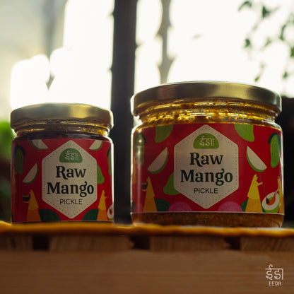 Two jars of Eeda Kairi Achar on a wooden shelf